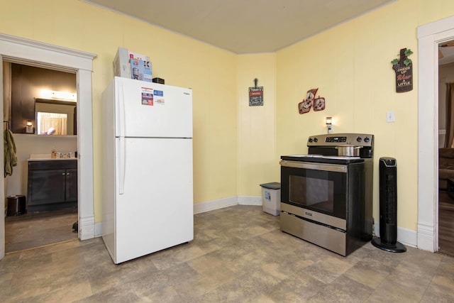 kitchen with white refrigerator, sink, and stainless steel range with electric cooktop