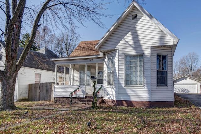 view of front of house with a porch, a garage, and an outdoor structure