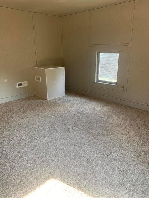 unfurnished room with light colored carpet