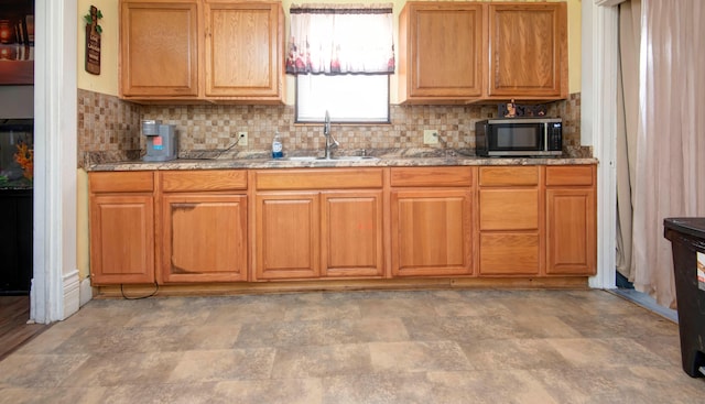 kitchen featuring tasteful backsplash and sink