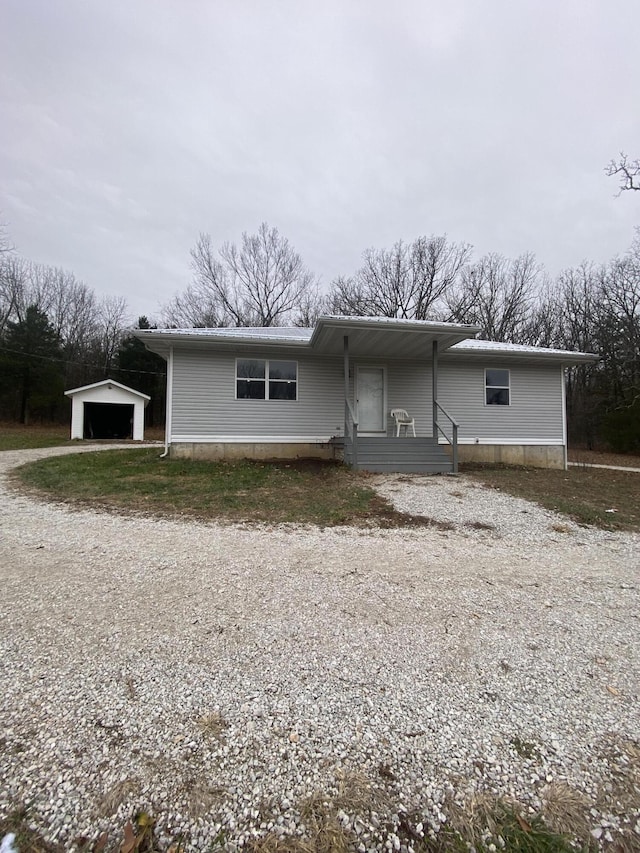 view of front of home featuring a garage and an outdoor structure