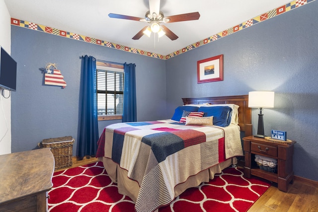 bedroom with light hardwood / wood-style floors and ceiling fan