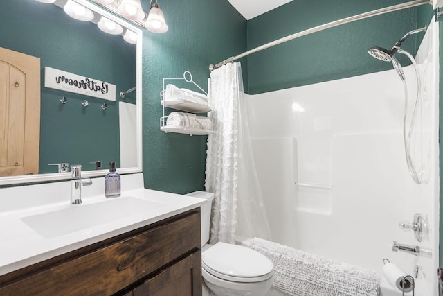 bathroom featuring vanity, curtained shower, and toilet