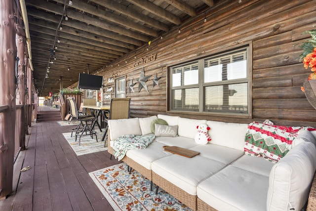 wooden deck with an outdoor living space