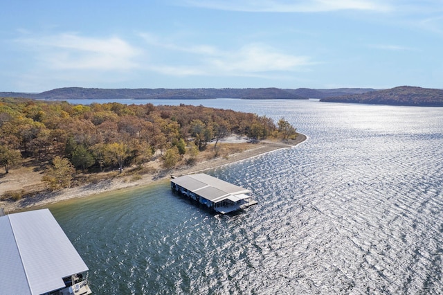 drone / aerial view with a water and mountain view