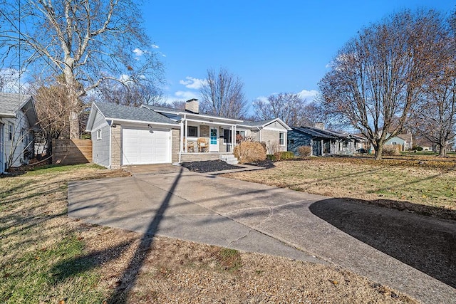 single story home with a garage, covered porch, and a front lawn