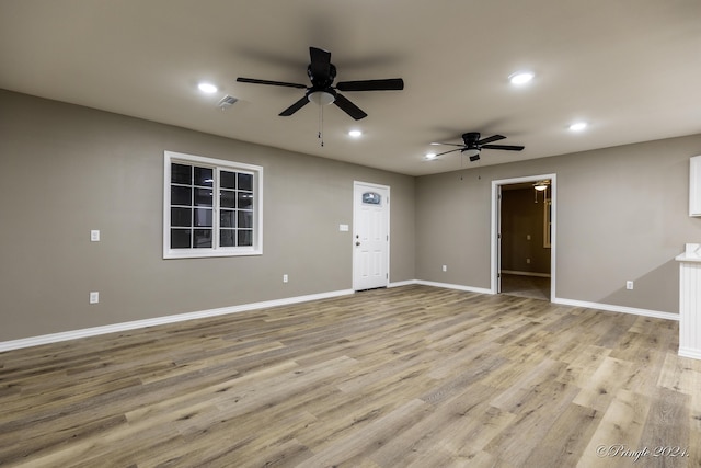 unfurnished living room with ceiling fan and light hardwood / wood-style flooring