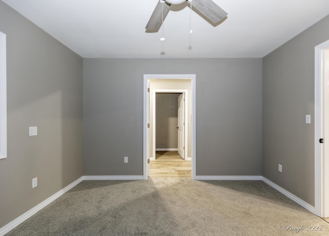 carpeted empty room with ceiling fan