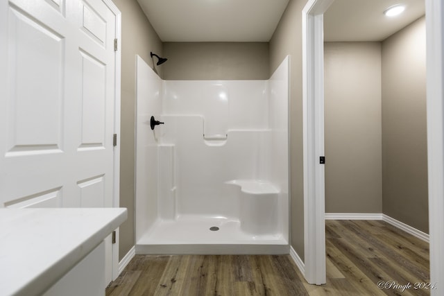 bathroom featuring a shower and wood-type flooring
