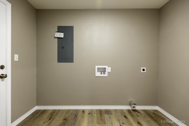 washroom with electric dryer hookup, hookup for a washing machine, electric panel, and light hardwood / wood-style flooring