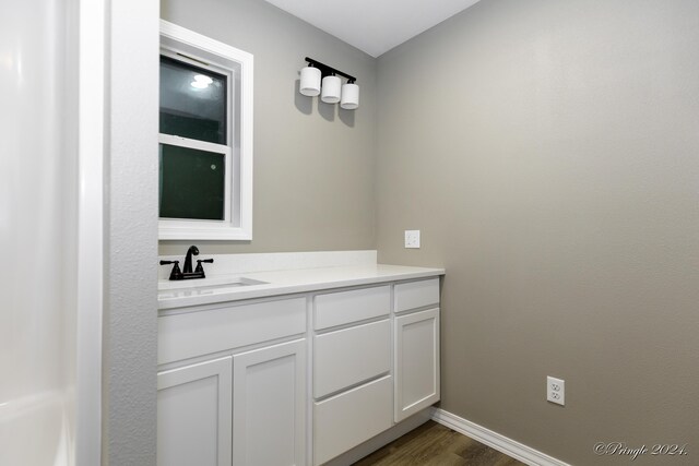 bathroom featuring vanity and hardwood / wood-style flooring
