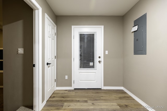 entryway with electric panel and light hardwood / wood-style flooring