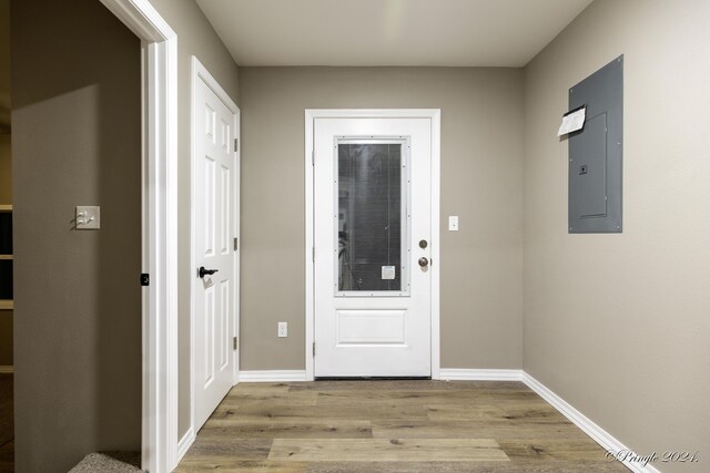 entryway with electric panel and light hardwood / wood-style flooring