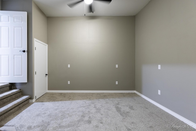 unfurnished room featuring light carpet and ceiling fan