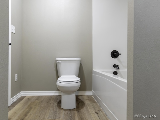 bathroom with wood-type flooring and toilet