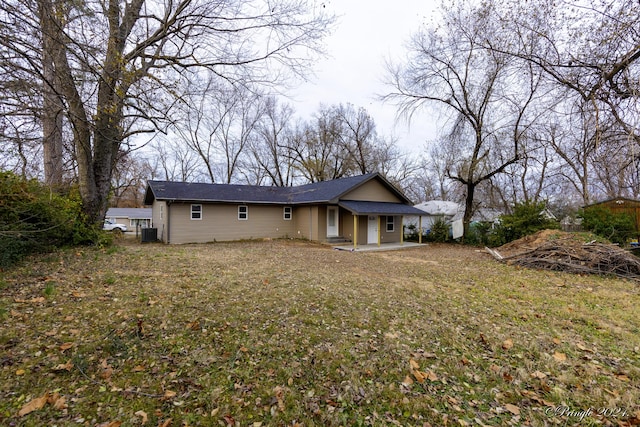 back of house with a lawn