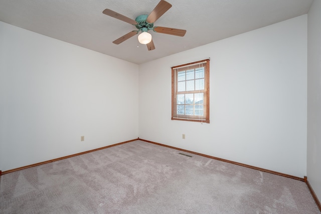 unfurnished room featuring light carpet and ceiling fan