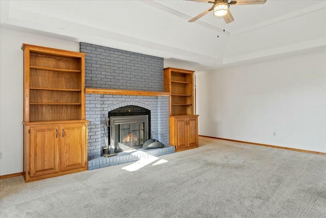 unfurnished living room featuring ceiling fan, light carpet, and a brick fireplace