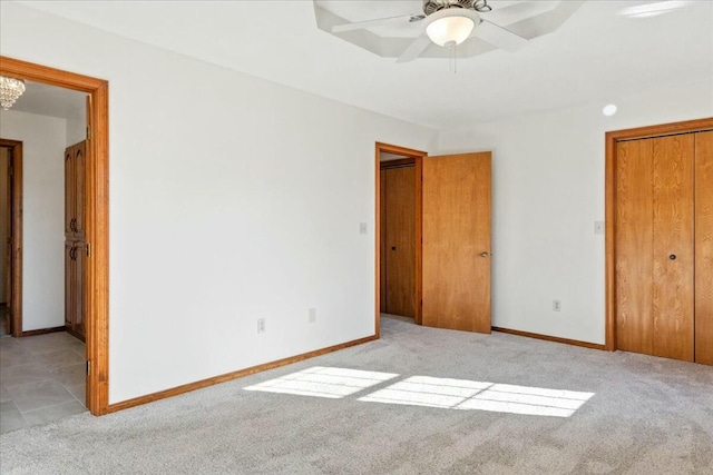 unfurnished bedroom featuring ceiling fan and light colored carpet