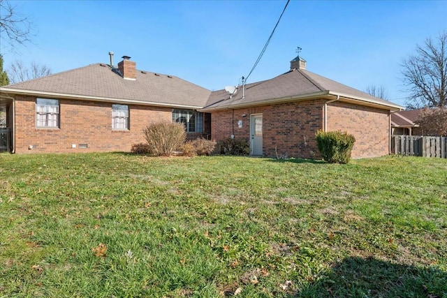 back of house with a lawn