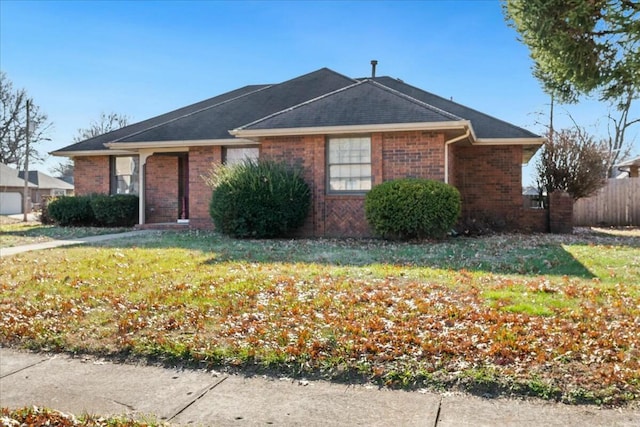 ranch-style home featuring a front yard