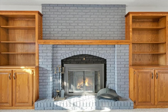 room details featuring carpet floors and a brick fireplace