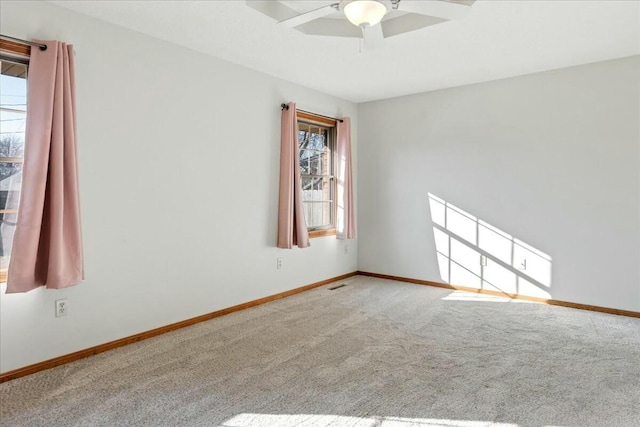 carpeted empty room with ceiling fan