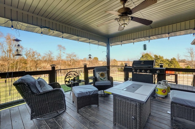 wooden deck featuring a grill, ceiling fan, and an outdoor hangout area