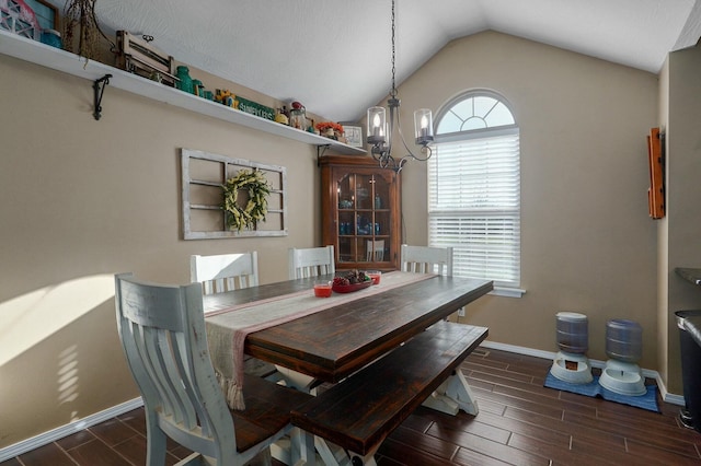 dining area featuring an inviting chandelier, dark wood-type flooring, and vaulted ceiling