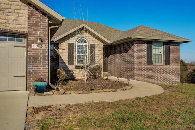 doorway to property with a garage