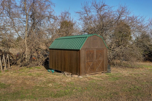 view of outbuilding featuring a lawn