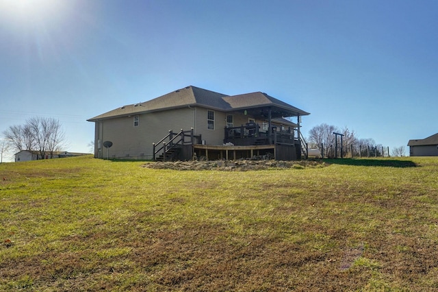 back of house featuring a deck and a yard