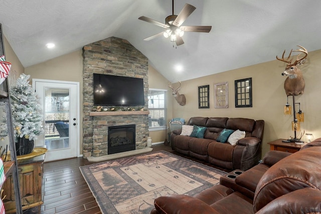 living room featuring lofted ceiling, ceiling fan, a textured ceiling, a fireplace, and dark hardwood / wood-style flooring