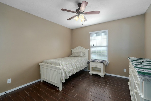 bedroom featuring a textured ceiling, ceiling fan, and dark wood-type flooring