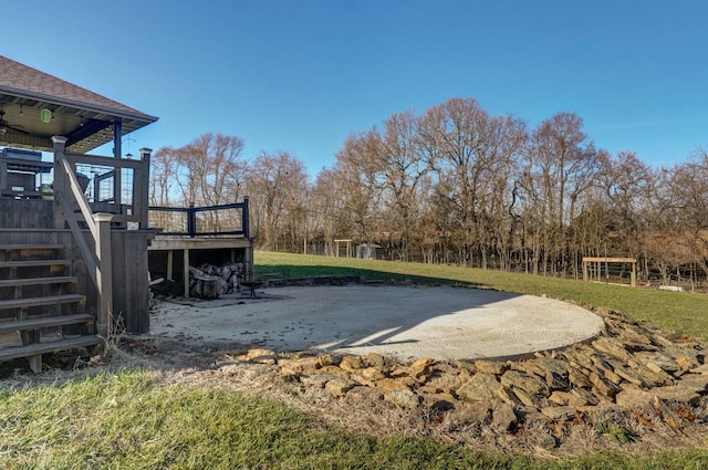 view of yard featuring a patio and a wooden deck