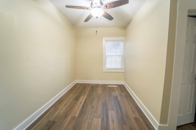 empty room with a textured ceiling, dark hardwood / wood-style flooring, and ceiling fan