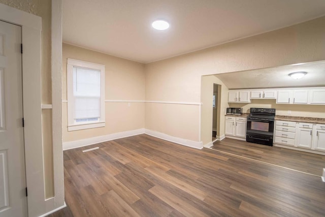 kitchen with white cabinets, dark hardwood / wood-style flooring, and black range with electric cooktop