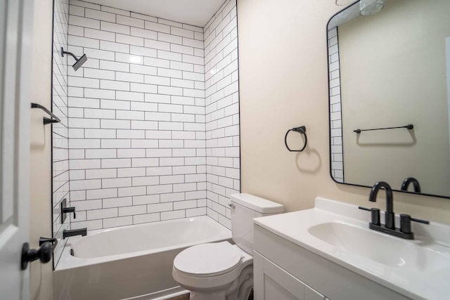 full bathroom featuring vanity, toilet, and tiled shower / bath