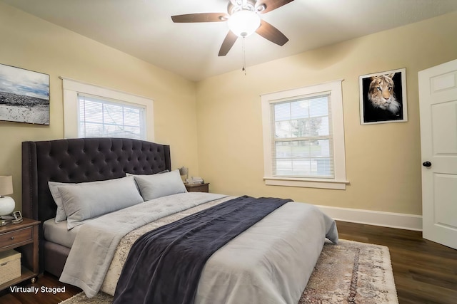 bedroom with dark hardwood / wood-style floors and ceiling fan