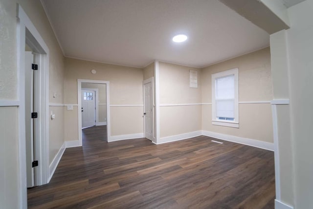 unfurnished room featuring dark wood-type flooring