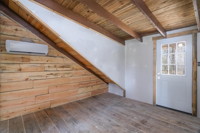 interior space with a wall mounted air conditioner, wood ceiling, wooden walls, wood-type flooring, and beamed ceiling