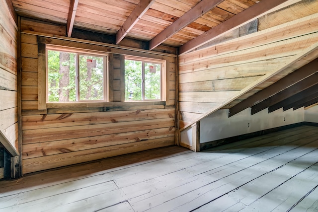 interior space featuring beam ceiling, wood walls, hardwood / wood-style floors, and wood ceiling