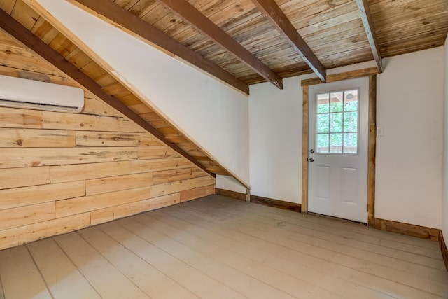 additional living space with hardwood / wood-style flooring, a wall mounted AC, wooden ceiling, and wood walls