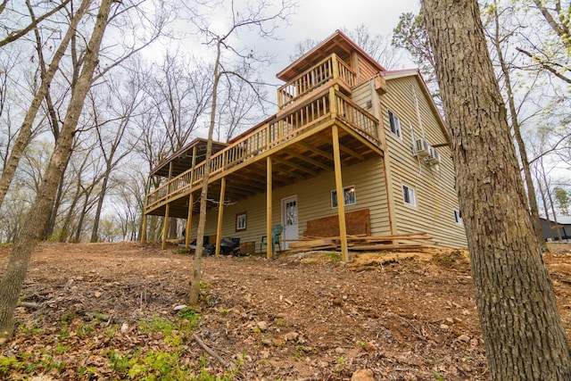 rear view of property featuring a wooden deck