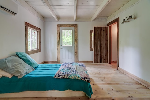 bedroom with beam ceiling, light wood-type flooring, a wall unit AC, and multiple windows