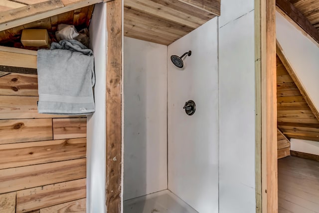 bathroom featuring wooden walls, hardwood / wood-style floors, and wooden ceiling