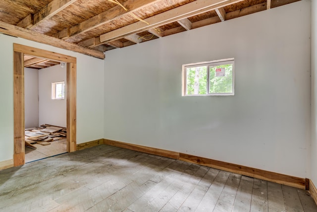 basement featuring hardwood / wood-style floors and plenty of natural light