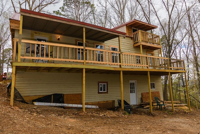 back of house featuring a balcony