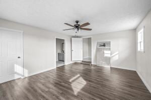 unfurnished room featuring ceiling fan and dark hardwood / wood-style flooring