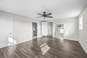 9800 Red Spring Rd, Mountain Grove, MO 65711 - unfurnished living room featuring a ceiling fan and wood finished floors